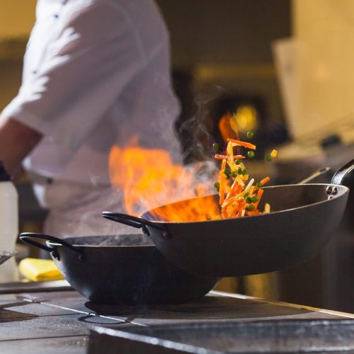 cook making dinner in the kitchen of high-end restaurant