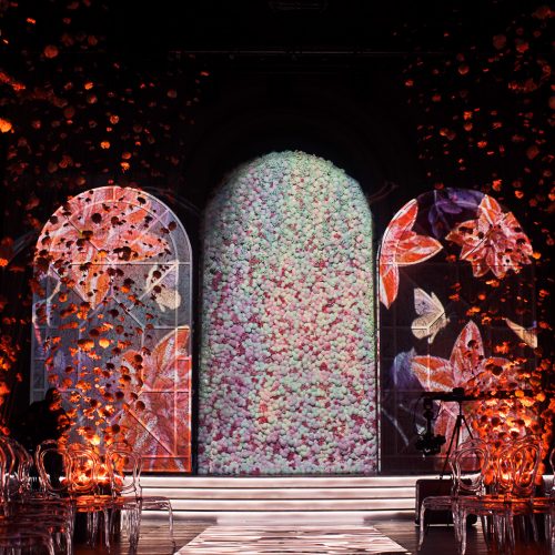 glance-path-leads-bright-archs-with-flowers-dark-room